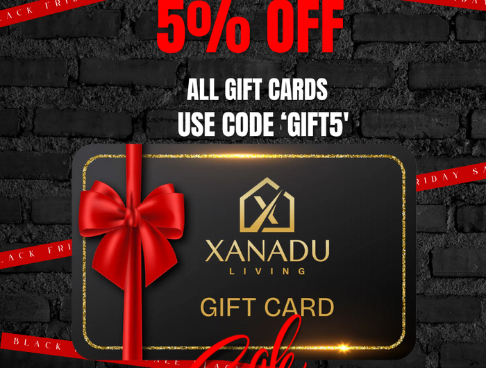 Black Friday promotional poster for XANADU Living gift cards with a red bow on a black brick background.