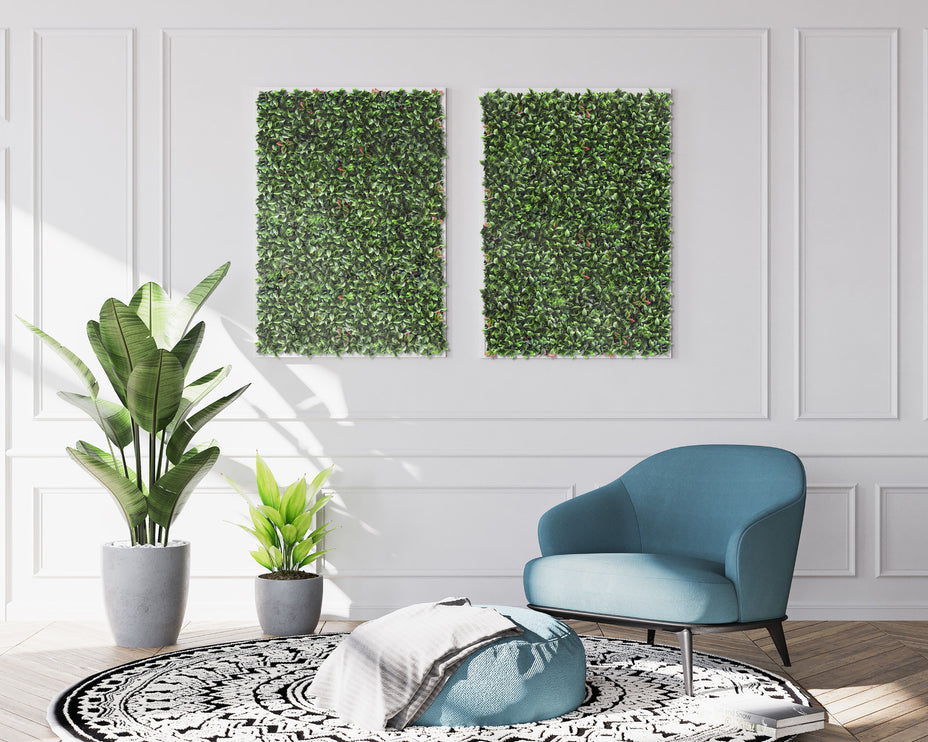 Modern living room with a blue armchair, ottoman, and decorative plants.
