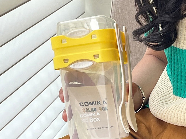Yellow Portable salad cup with ingredient compartment and fork and spoon - enjoy breakfast on the go