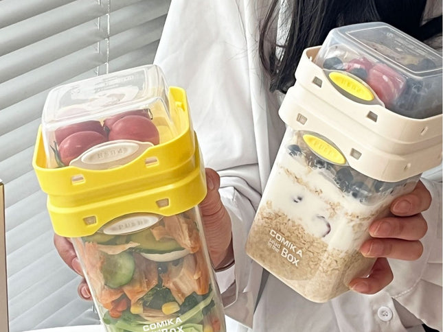 Yellow Portable salad cup with ingredient compartment and fork and spoon - enjoy breakfast on the go