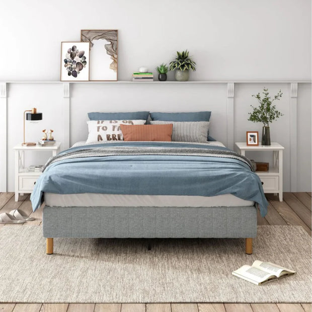 Bedroom with a gray bed, blue bedding, and decorative pillows.